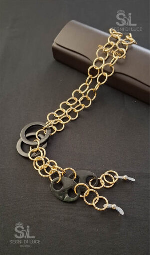 Reggi-occhiali donna artigianale in metallo dorato con inserti in ematite nera, dal contrasto grafico essenziale. Creazione pezzo unico realizzata a mano da Segni di Luce.